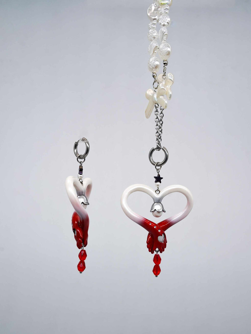 Blood-red pearl witch's wand necklace and earring set with festive design in red and white.