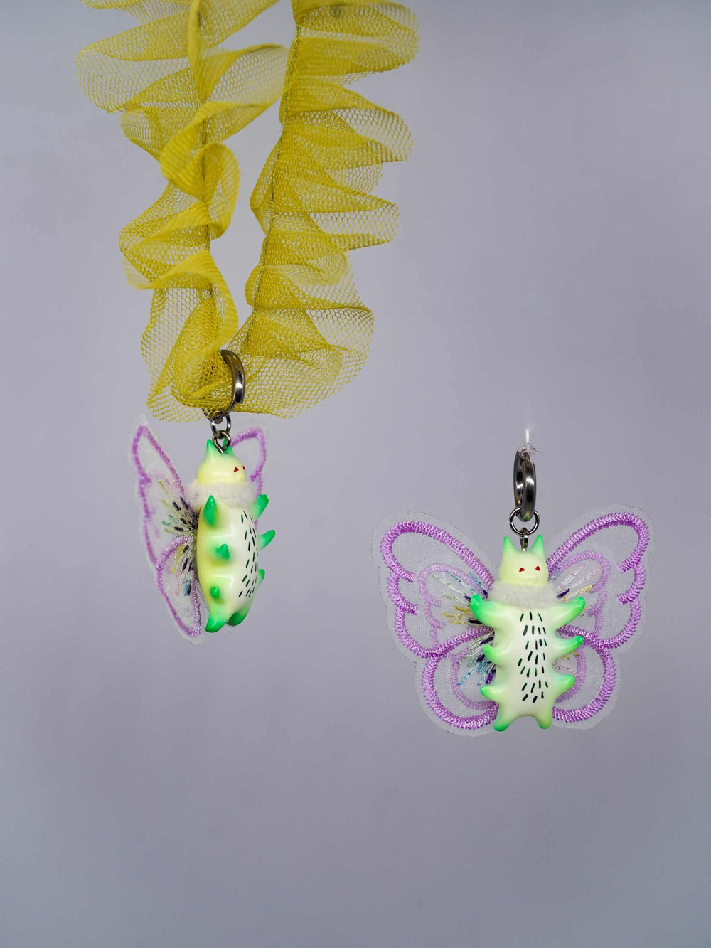Calico catcaterpillar necklace and earrings with colorful butterfly wings and whimsical design.