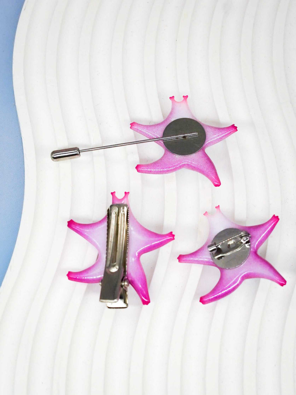 SeaStar cat hairclip and brooch in pearl color blocking and pink, featuring vibrant magenta and navy shades, polyurethane resin and titanium steel materials.