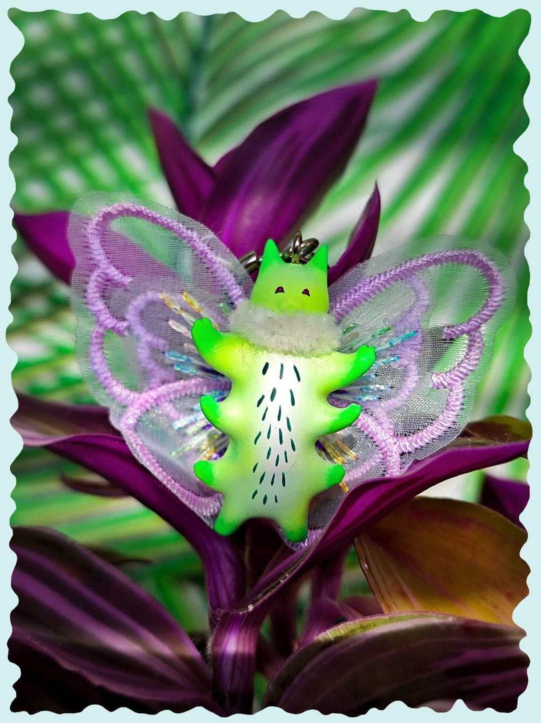 Calico catcaterpillar necklace and earrings with whimsical design and multiple ears.