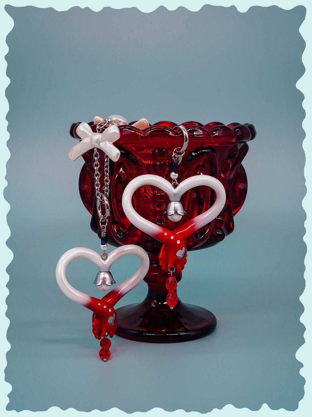 Blood-red pearl witch's wand necklace and earrings with heart design, inspired by fairy's wand, featuring red and white polyurethane resin and titanium steel accents.