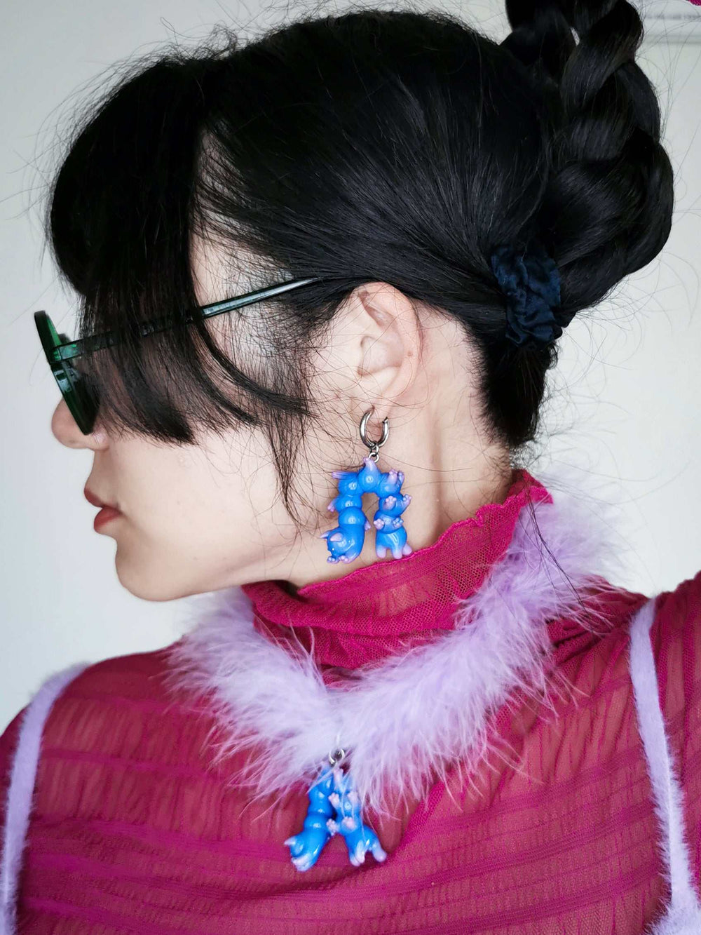 Blue cat necklace and earring set with purple gradient design, worn by a person.
