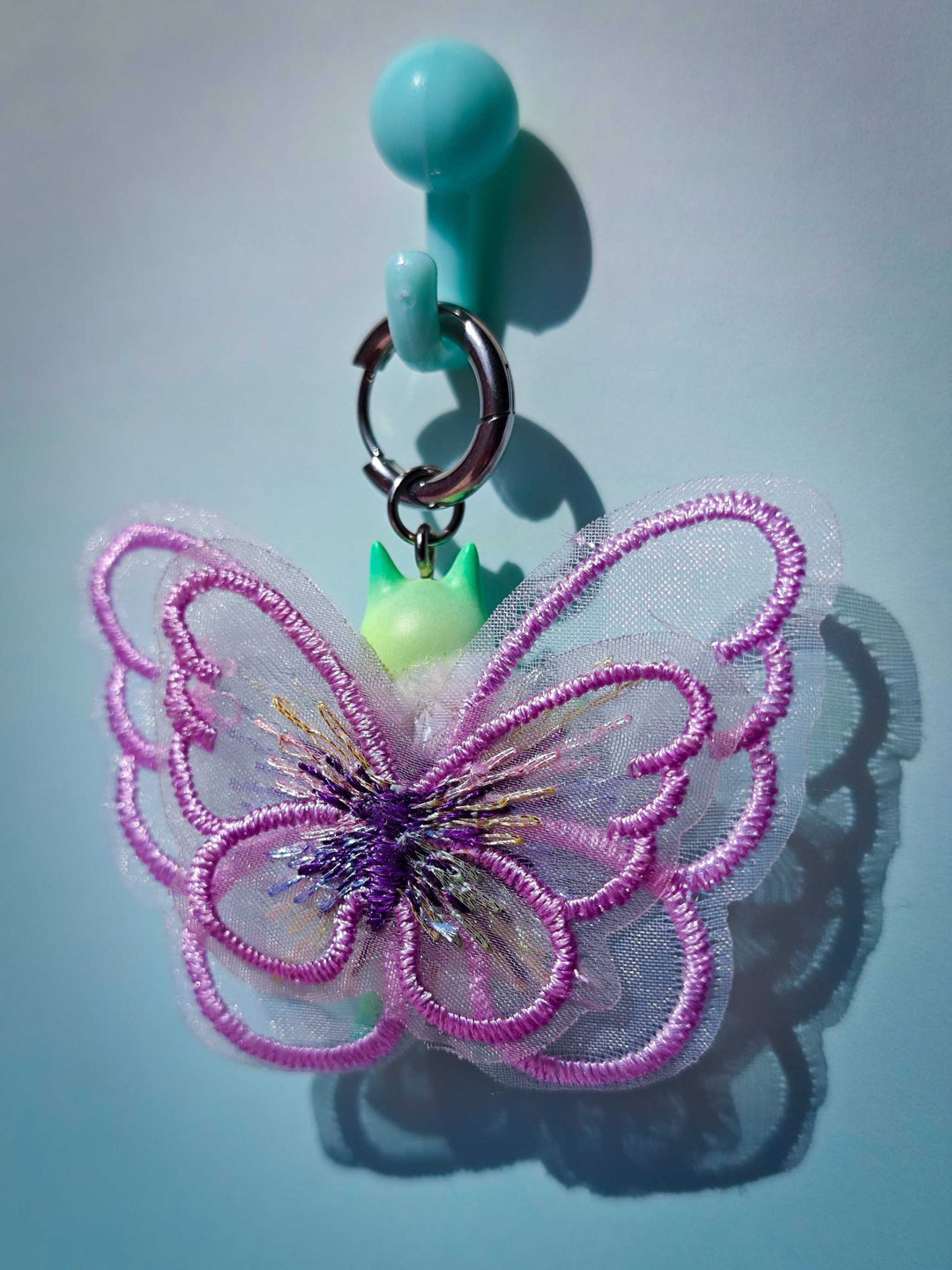 Calico catcaterpillar necklace and earring set with playful cat-ear design.