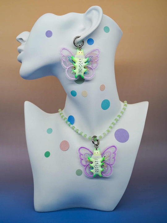 Calico catcaterpillar necklace and earring set with playful design and unique cat-shaped elements.