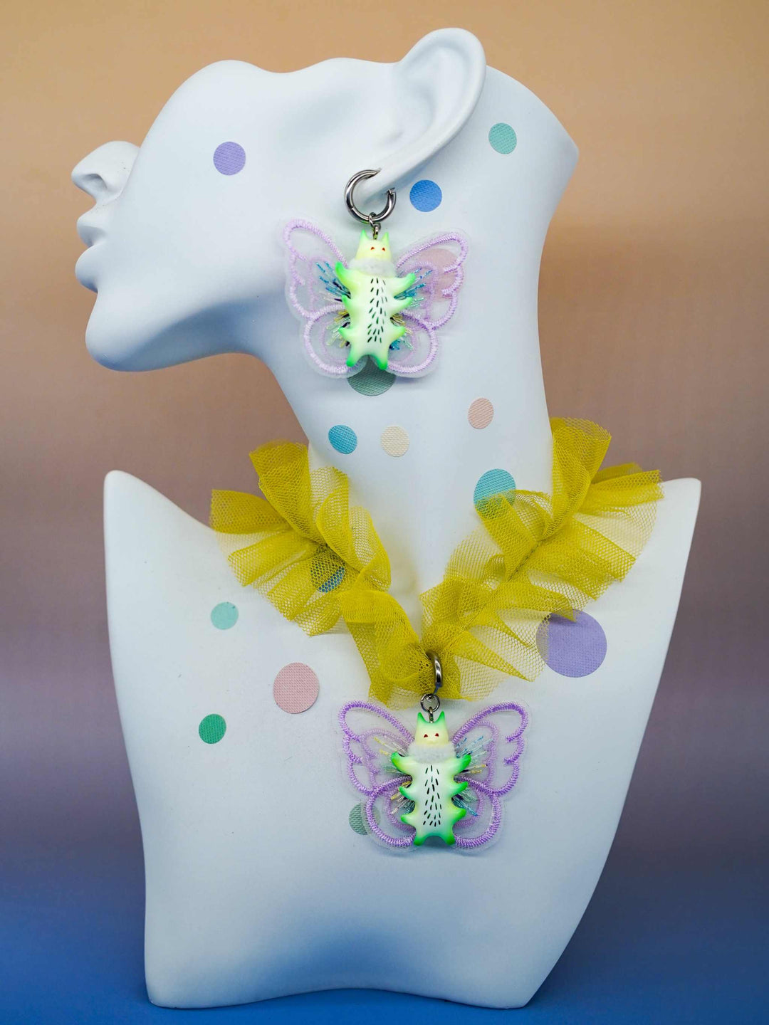 Calico catcaterpillar necklace and earring set with playful ear design.