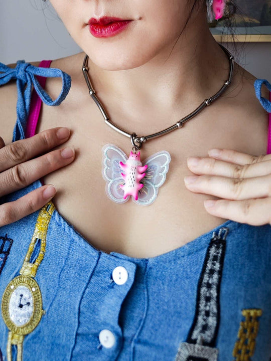 Butterfly cat necklace with flamingo pink body and mint green wings.