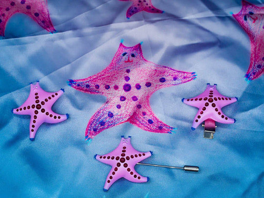 SeaStar cat hairclip and brooch in magenta and navy, featuring a playful cat shape, made from polyurethane resin and titanium steel.