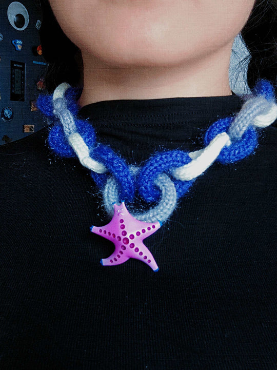 Magenta and navy SeaStar cat hairclip and brooch with vibrant colors.