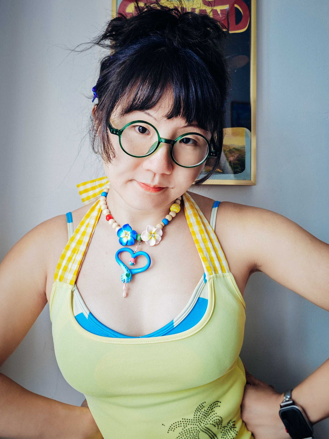 Woman wearing colorful hands necklace and matching earrings with blue and pink fairy wand design