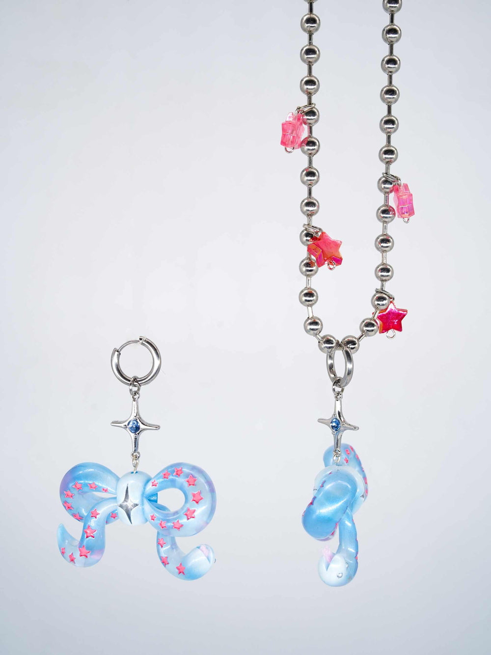 Ice blue snake bowtie necklace and earring with pink star accents and ball chain necklace
