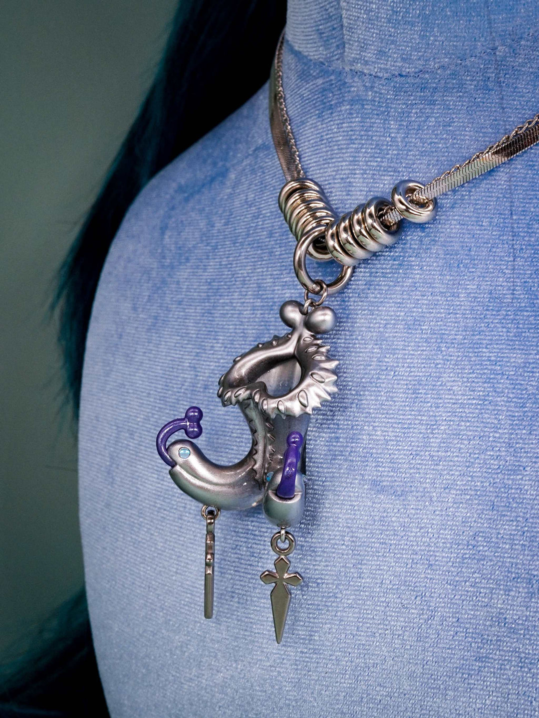 Twin-headed pitcher serpent earrings with violet tendrils and silver metal spikes