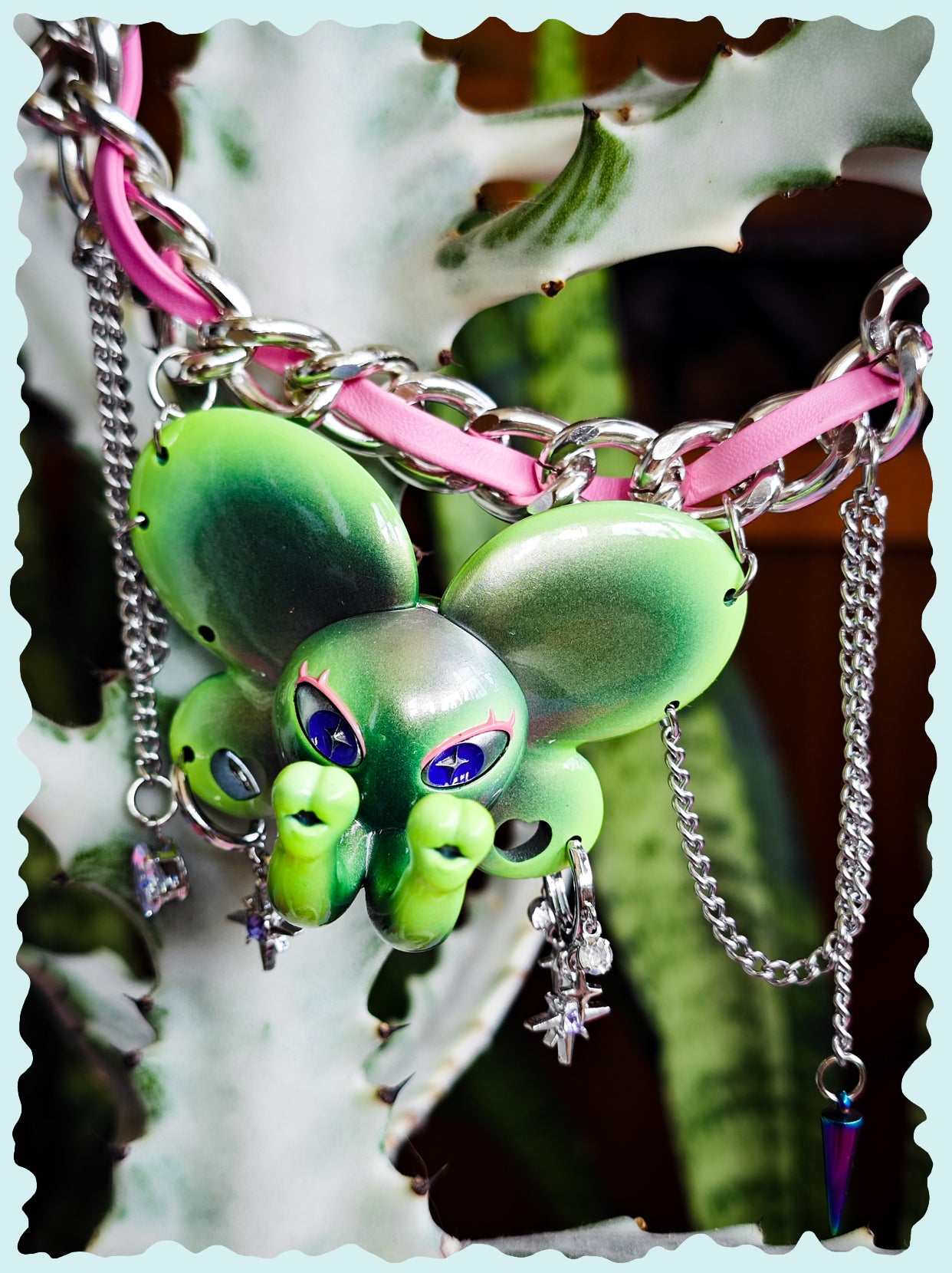 Twin-Trunk Diva Elephant Necklace in metallic alien apple green with two trunks and starry blue-purple eyes