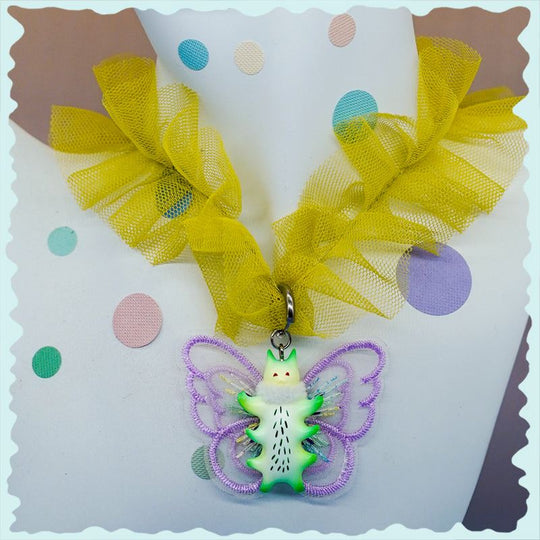 Butterfly cat necklace with green fur snood and earrings, featuring lavender wings and whimsical design.