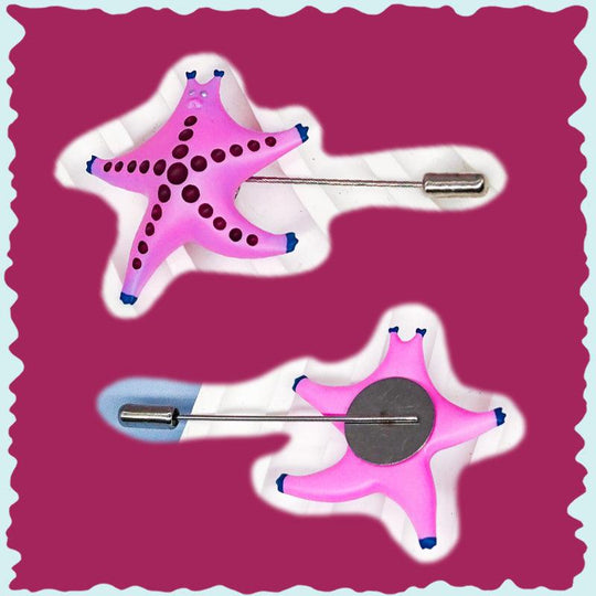 Pink SeaStar cat hairclip and brooch in pearl color blocking with magenta and navy accents, made of polyurethane resins and titanium steel.