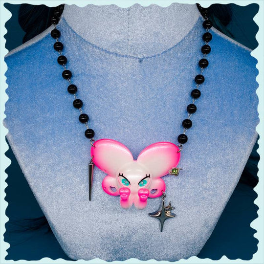 Twin-Trunk Diva Elephant Necklace in pink pearl white with two trunks and sparkling blue-green eyes
