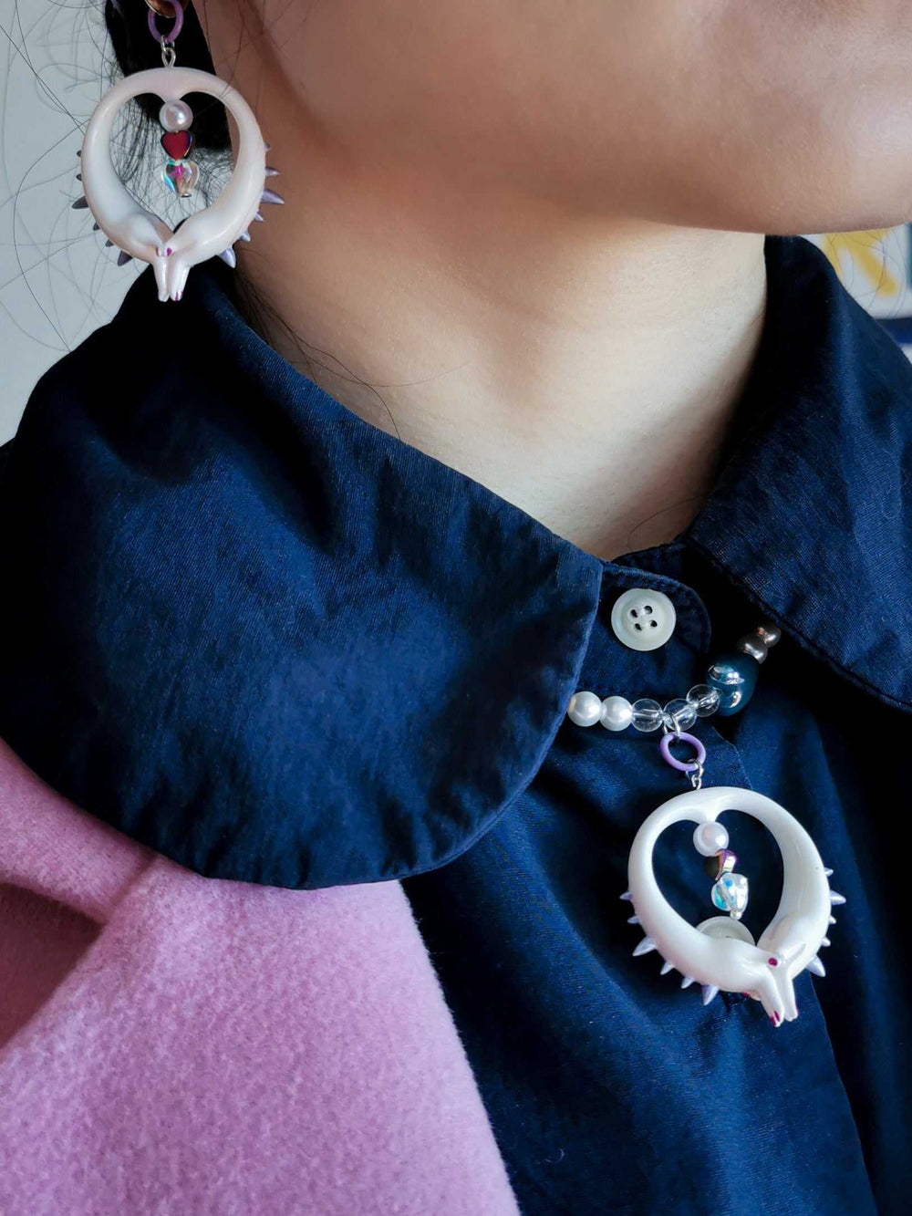 Sennen Goroshi light pink pearly necklace and earrings set with bold bad girl gesture pendant worn on a person